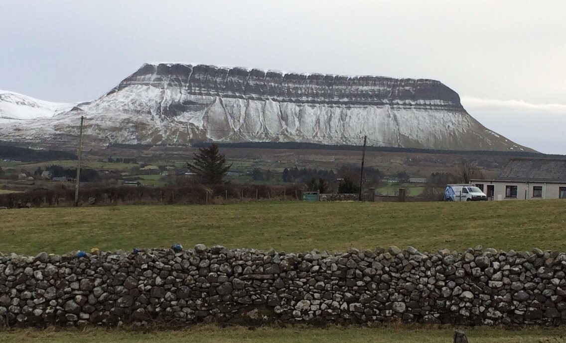 The long flat-topped Bembulben mountain with its gullied sides, with a light covering of snow.